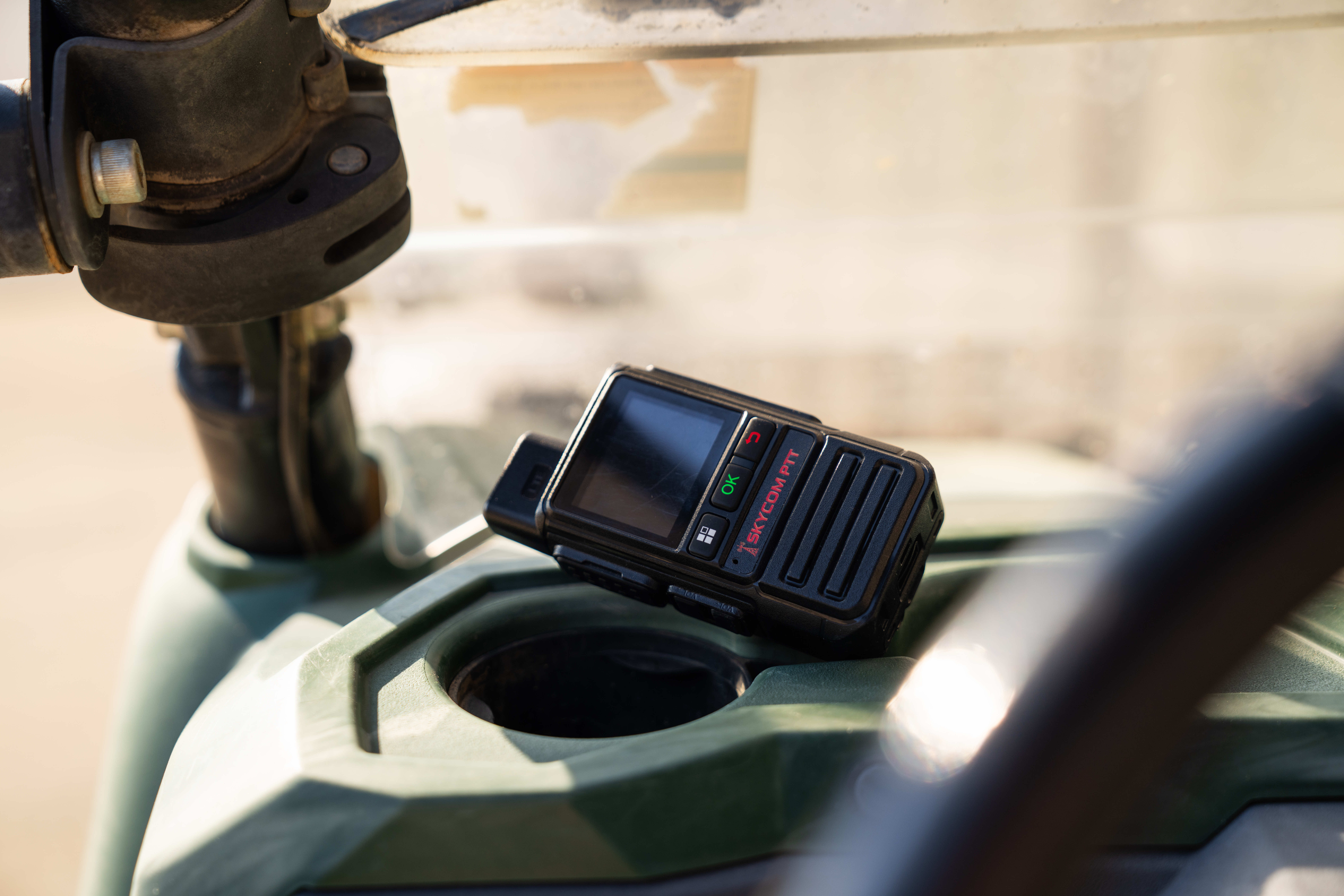 SkyCom PTT radio mounted on the dashboard of a utility vehicle